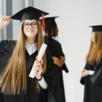 Educational theme: graduating student girl in an academic gown.