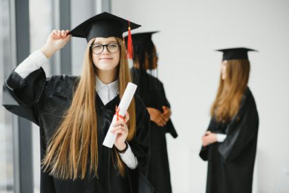 Educational theme: graduating student girl in an academic gown.