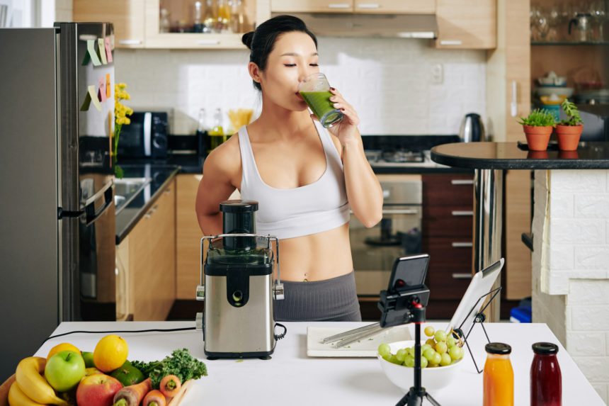 Female athlete drinking green smoothie