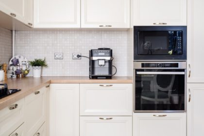 Modern design kitchen with electric appliances and wooden worktop