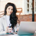 Woman with long luxurious hair dressed elegantly looking into distance