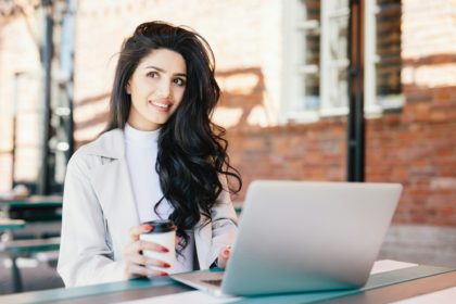 Woman with long luxurious hair dressed elegantly looking into distance