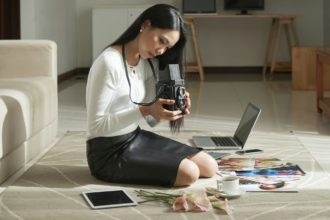 Young Photographer Choosing Images on Camera